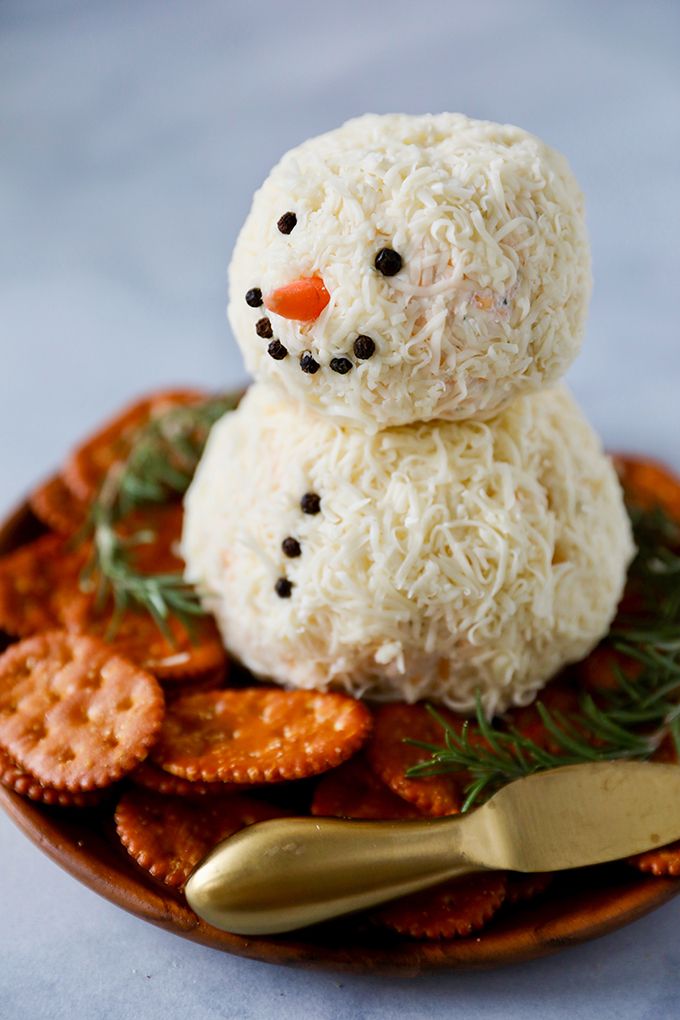 a snowman made out of rice and crackers on a plate