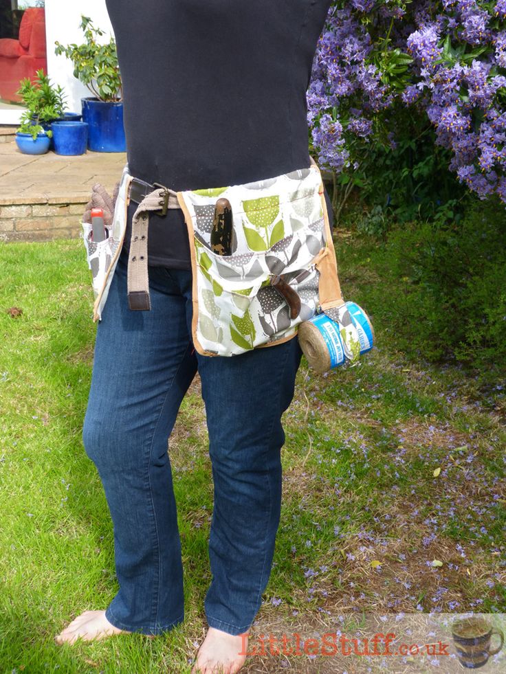 a woman is standing in the grass with her back to the camera, holding a beer can