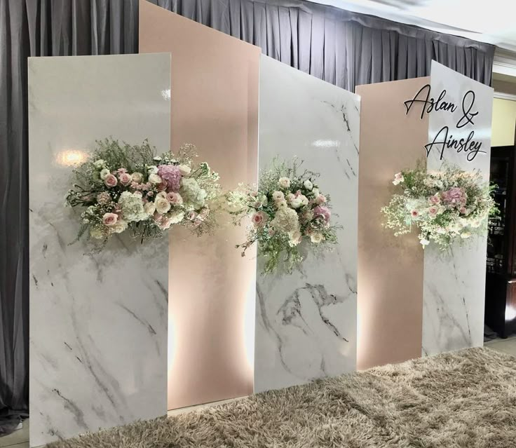 three white marble walls with flowers on them