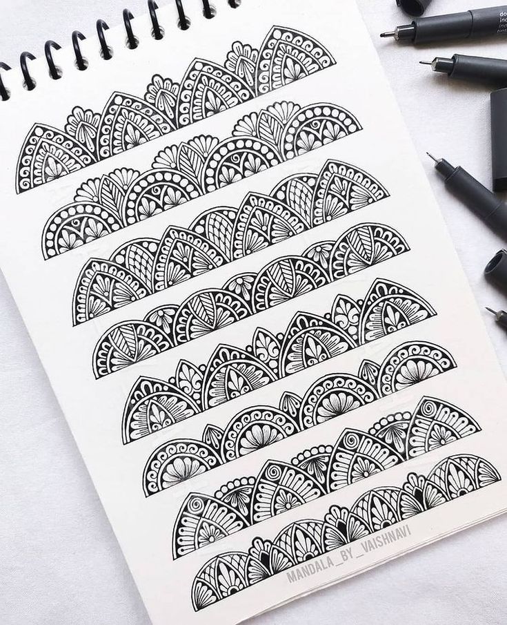 an open notebook with black and white designs on it