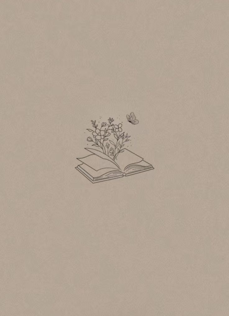 an open book sitting on top of a table next to a butterfly flying over it