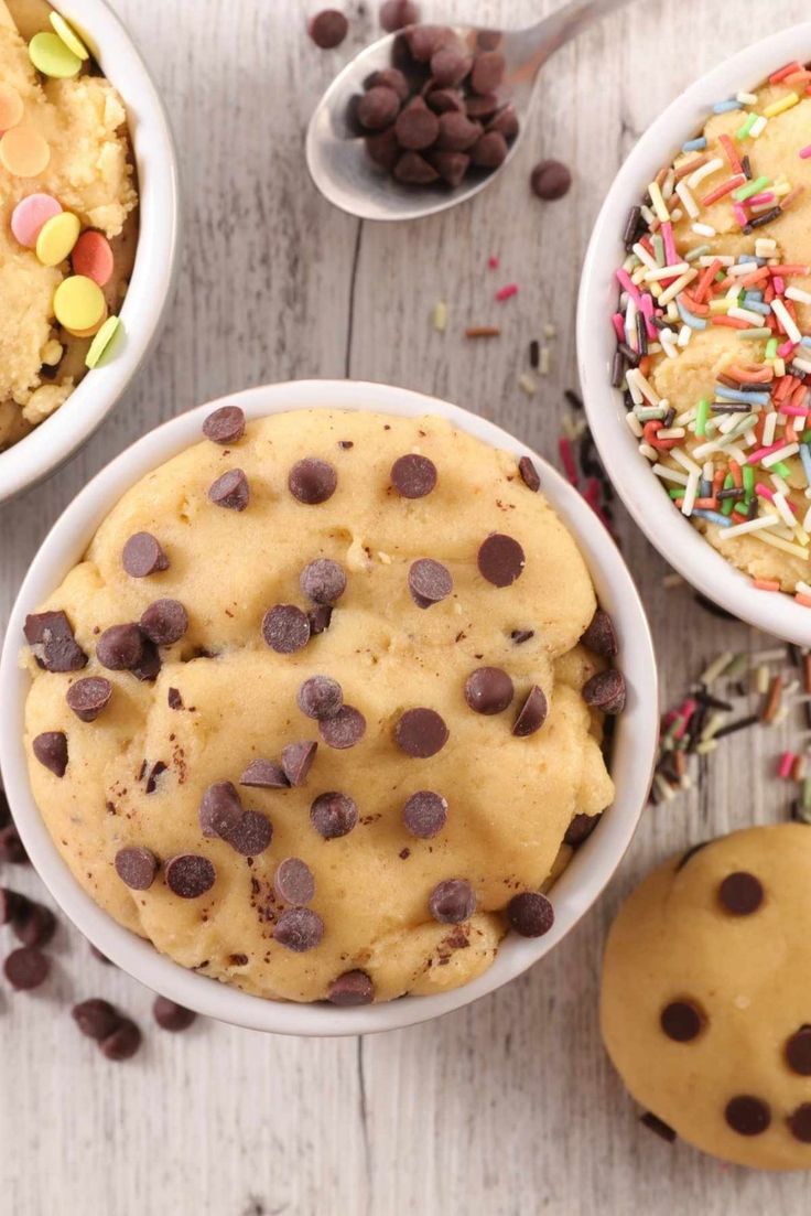 three bowls filled with chocolate chip cookies and sprinkles next to cookie dough