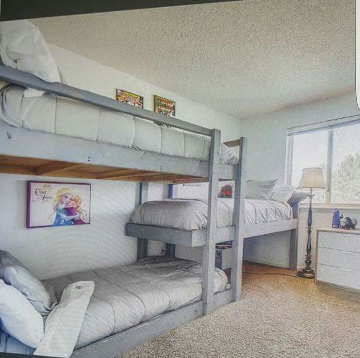 a bedroom with bunk beds and white walls