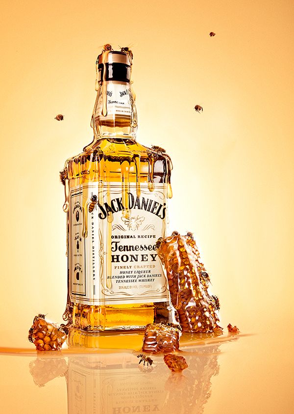 a bottle of jack daniels honey and some nuts