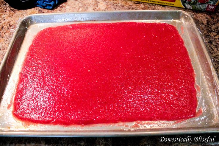 a pan filled with red food sitting on top of a counter