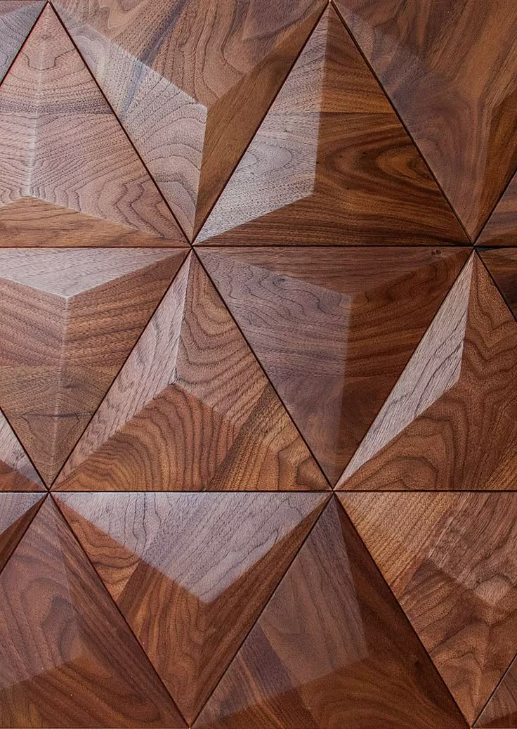 a wooden wall with many different shapes and sizes on it's sides, including triangles