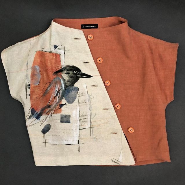 an orange and white shirt with a bird on it