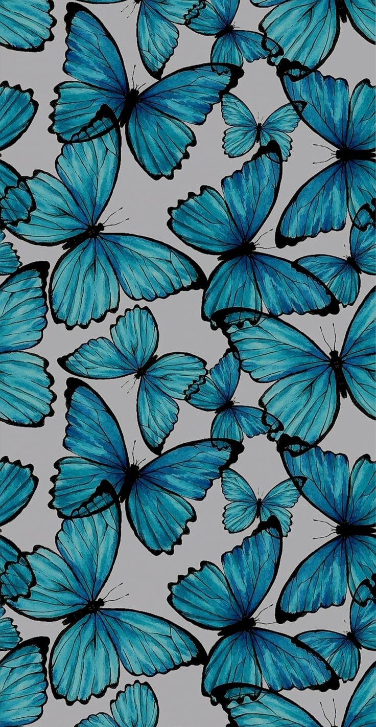 many blue butterflies flying in the sky with their wings spread out to look like they're