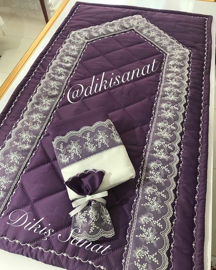 a quilted table runner with an embroidered name on it