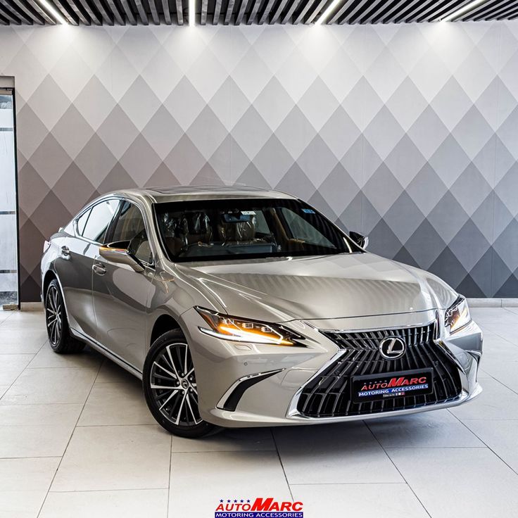 a silver car is parked in a showroom