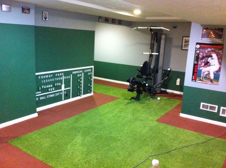 a room with green and red carpeted flooring in front of a wall mounted television