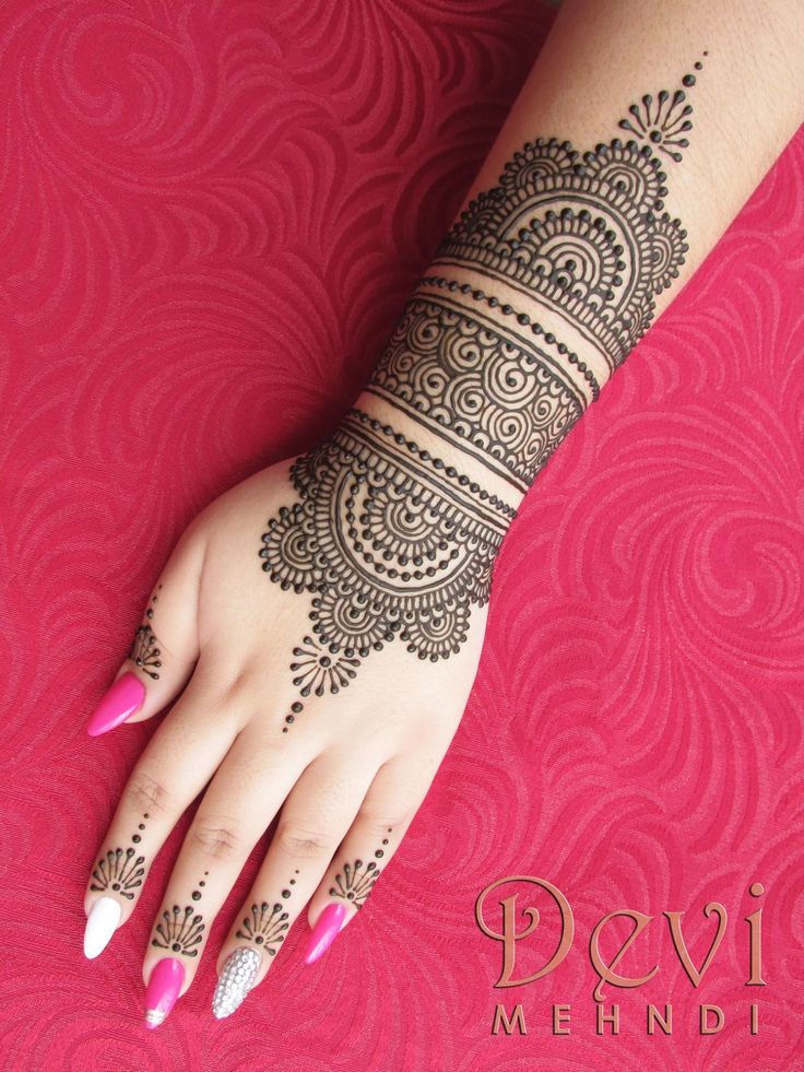 a woman's hand with henna tattoos on it