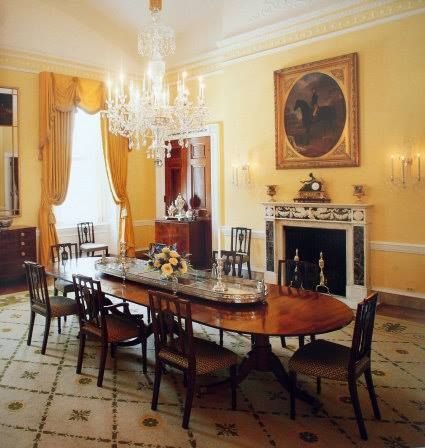 a formal dining room with chandelier and fireplace