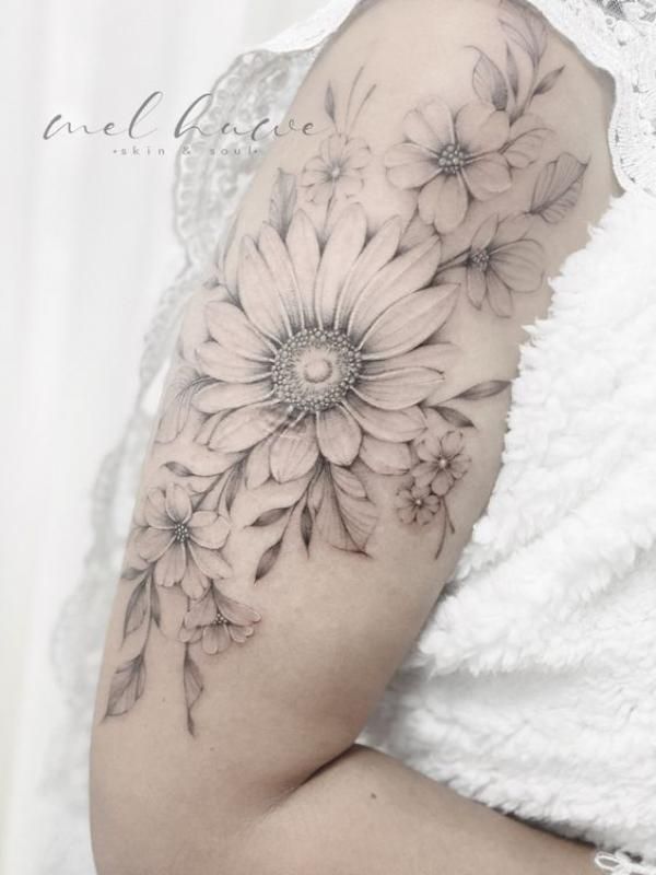 a woman's arm with flowers on it