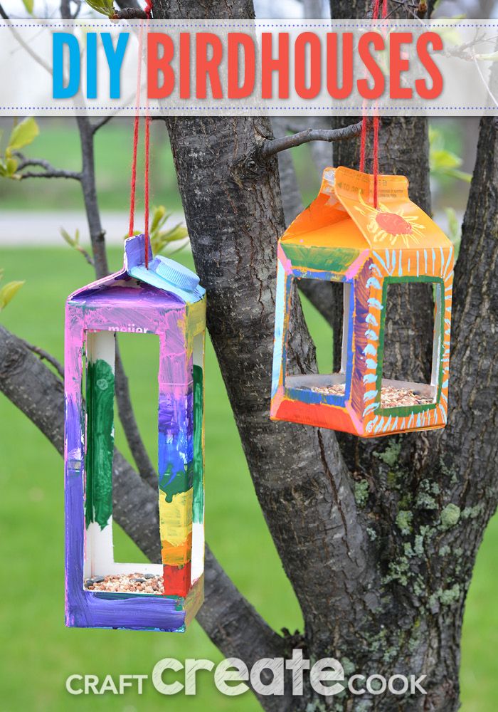 colorful birdhouses hanging from a tree with text overlay that says diy birdhouses