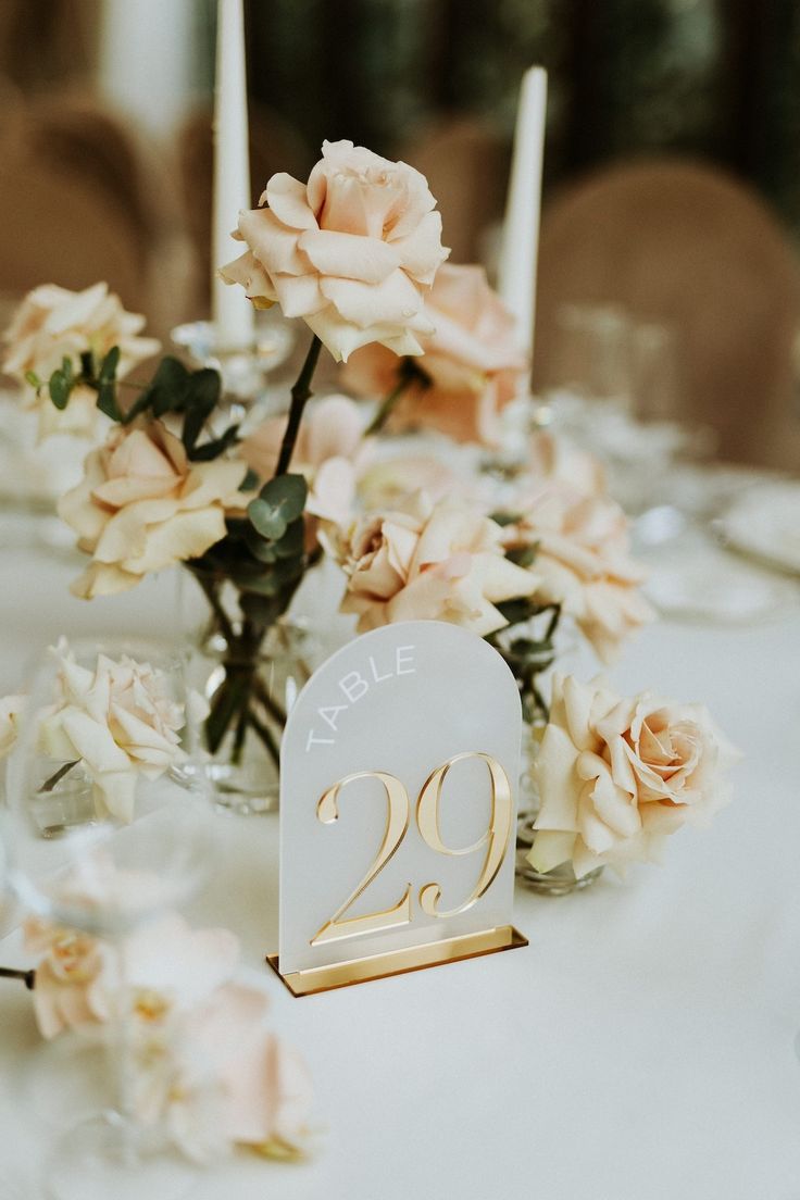 the table is set with flowers and candles