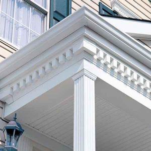 a white porch with columns and windows