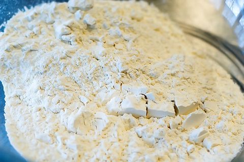 a blue bowl filled with white powdered food