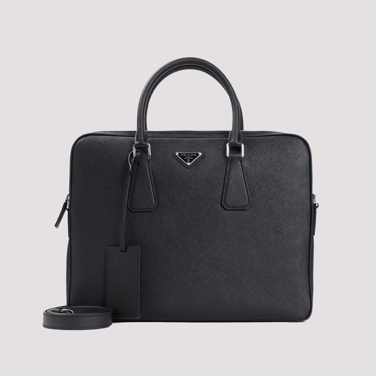 Indulge in the luxurious texture of 100% Saffiano calf leather with this stylish briefcase. Perfect for work or travel, it effortlessly combines practicality and sophistication for the modern professional. Made from 100% Saffiano calf leather Spacious dimensions of W:36CM x H:28CM x D:5CM Perfect for work or travel Prada Luggage, Organizing Documents, Black Briefcase, Prada Saffiano, Leather Cap, Leather Briefcase, Pumps Flat, Prada Men, Business Attire