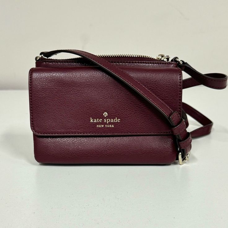 This Kate Spade Crossbody Bag Has A Textured Leather Exterior With An Adjustable Crossbody Strap. Features The Kate Spade Logo On The Front Flap Pocket. The Front Flap Has A Small Compartment And 2 Credit Card Slots. The Main Zippered Compartment Has A Slip Pocket. New Without Tags. There Is One Small Imperfection On The End Of The Strap. Approximate Size Of The Purse Is 7"(L) X 5"(H) X 1"(D). Kate Spade Crossbody Shoulder Bag With Phone Pocket, Kate Spade Crossbody Mobile Phone Bag, Kate Spade Crossbody Shoulder Bag For Mobile Phone, Elegant Kate Spade Bag With Cell Phone Pocket, Kate Spade Crossbody Bag, Kate Spade Logo, Spade Logo, Small Crossbody Bag, Small Crossbody