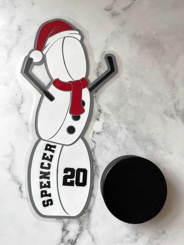 a hockey sticker with the number 20 on it next to an ice rink puck