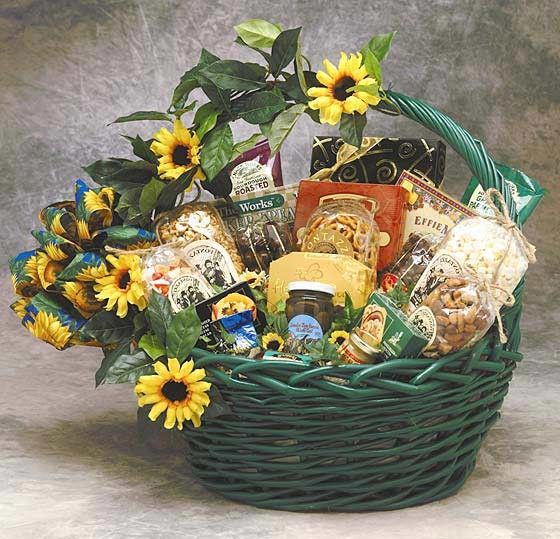 a basket filled with lots of different types of food and flowers on top of a table