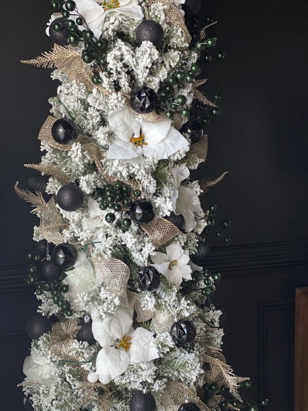 a decorated christmas tree with black and white ornaments