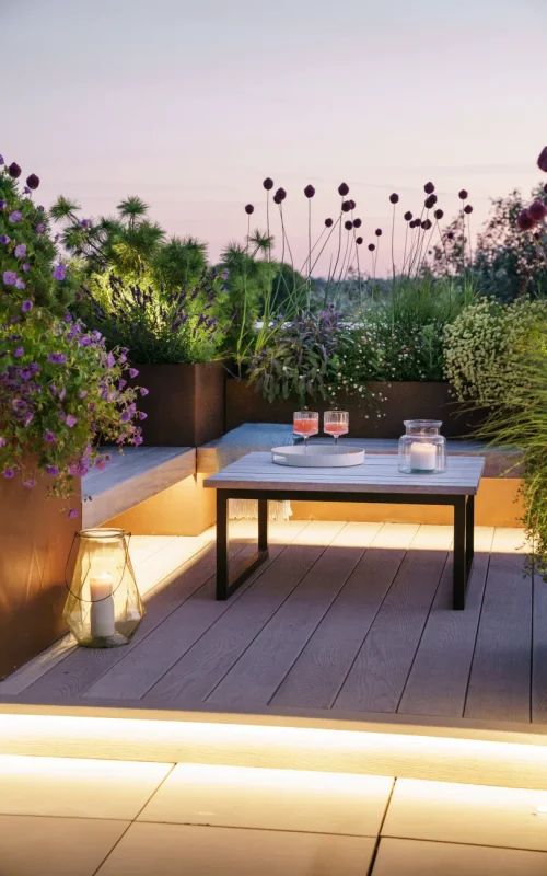 a table and some plants on a wooden deck