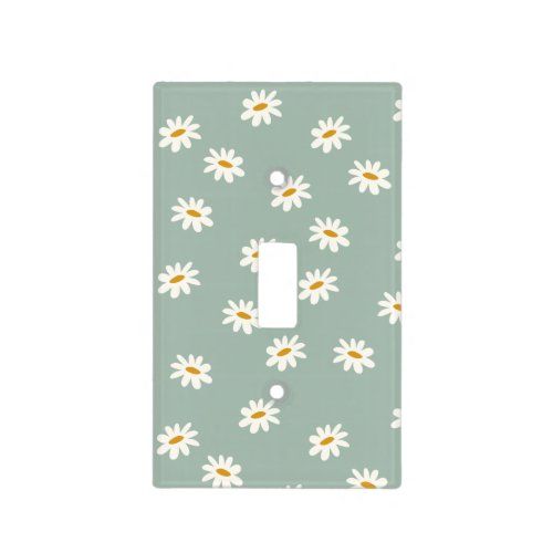 a light switch cover with white daisies on a green background and yellow dots in the middle