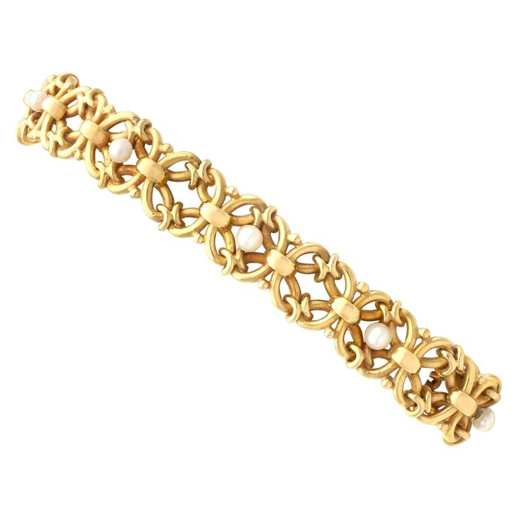 An impressive antique natural pearl and 18 karat yellow gold bracelet; part of our diverse antique jewelry and estate jewelry collections This stunning antique Victorian bracelet has been crafted in 18k yellow gold. The bracelet consists of eighteen pierced decorated intertwining links, incorporating ten alternating 3mm seed pearl set links. Each quatrefoil shaped link is conjoined with a cross style collar connector. The bracelet secures with a discreet integrated push fit clasp to one link, an Vintage Diamond Bracelet, Victorian Bracelet, Gold Eagle, Antique Bracelets, White Gold Set, Pearl Set, Natural Pearl, Yellow Gold Bracelet, Seed Pearl