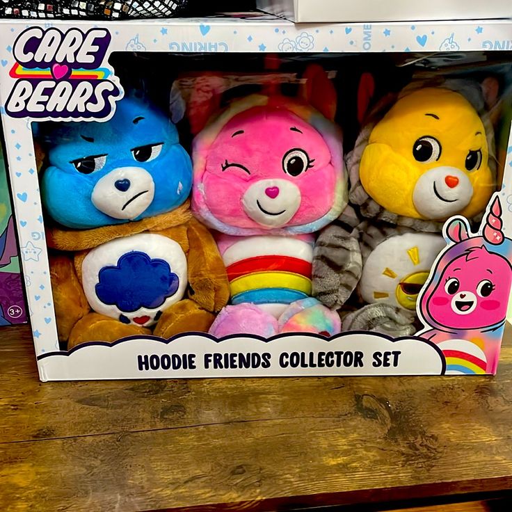 three stuffed animals in a box on a table