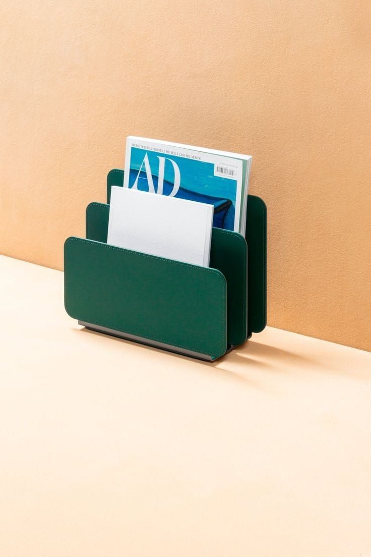 a desk with a magazine holder on top of it and a folder in the middle