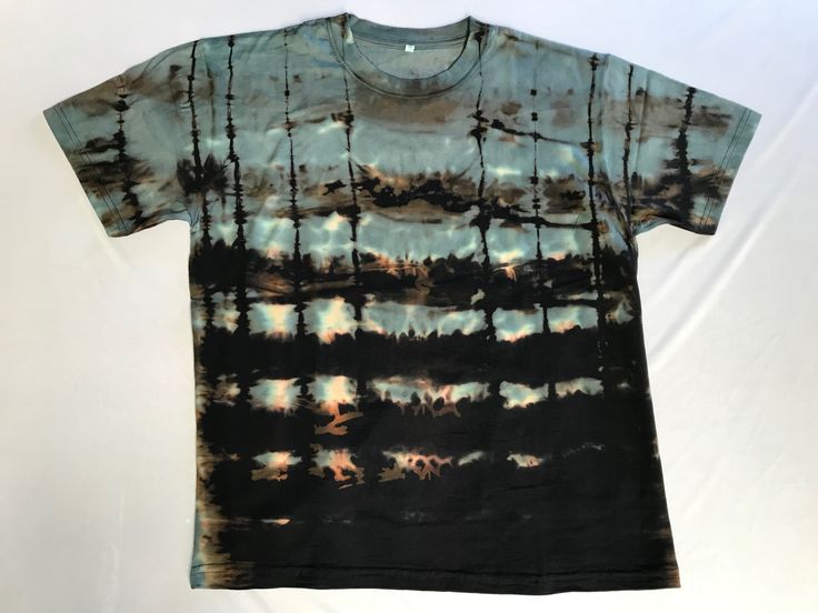 a t - shirt with trees and clouds on it