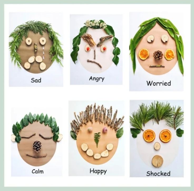 four different types of faces made out of wood with plants and leaves on them, including oranges