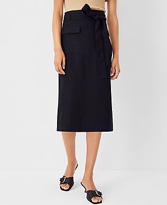 Elevate your wardrobe with the Ann Taylor Tie Waist Cargo Pencil Skirt, a blend of sophistication and practicality. This skirt is designed to cater to the modern woman's needs, featuring a sleek black color that pairs effortlessly with any top.

- **Size**: 14 (Regular)
- **Color**: Black
- **Material**: Shell: 67% Lyocell, 18% Linen, 15% Viscose; Lining: 100% Polyester
- **Gender**: Female
- **Length**: 28 inches long
- **Features**: Front flap cargo pockets, self-tie belt, belt loops, hidden b Summer Workwear Knee-length Cargo Skirt, Knee-length Cargo Skirt For Summer Workwear, Summer Knee-length Cargo Skirt For Workwear, Spring Utility Skirt For Workwear, Utility Skirt For Spring Workwear, Relaxed Tie Waist Skirt For Workwear, Utility Relaxed Skirt For Work, Spring Utility Style Belted Skirt, Spring Cargo Skirt With Side Pockets For Work