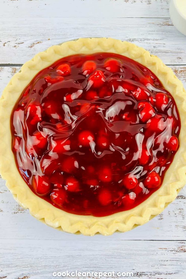 a cherry pie sitting on top of a wooden table