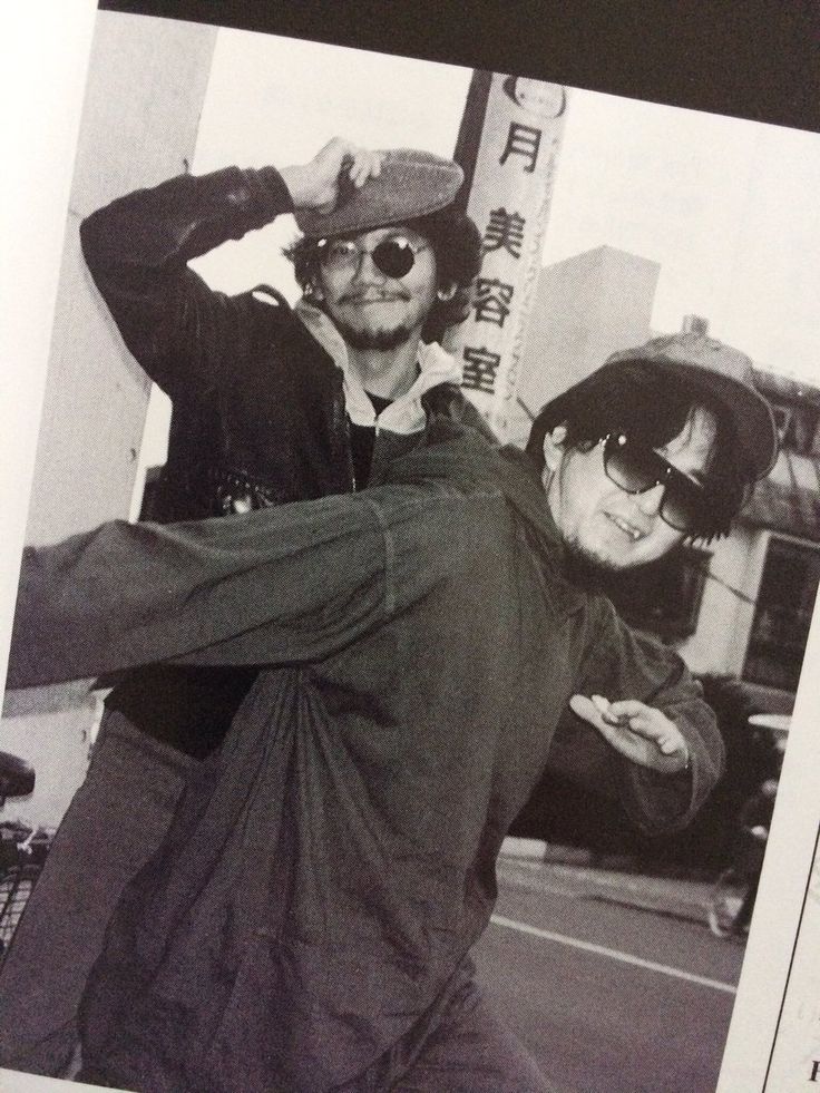 an old photo of two people dancing in the street