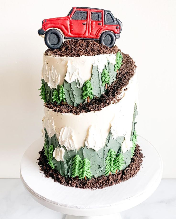 a three layer cake with a red truck on top