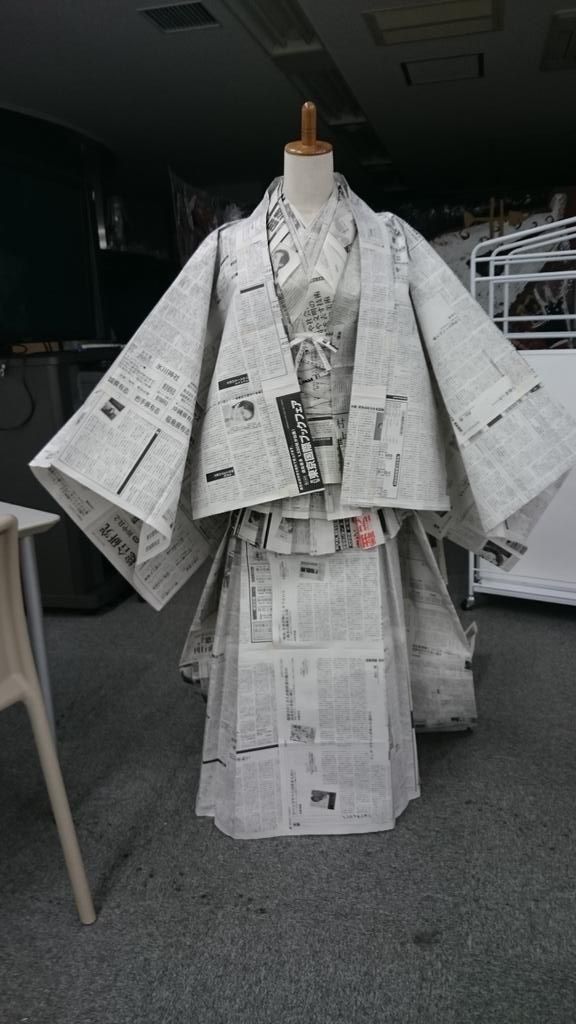 a dress made out of newspapers sitting on top of a table