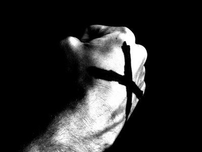 a hand with a cross painted on it's wrist is shown in black and white