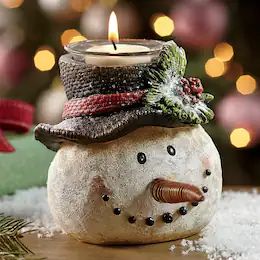 a snowman candle holder with a hat on it