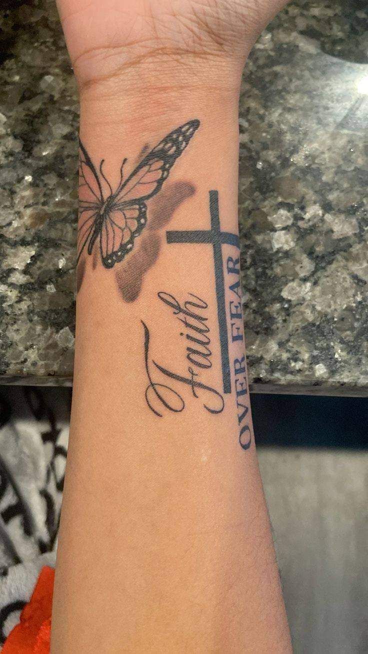 a woman's wrist with a butterfly on it and the words faith written in cursive writing