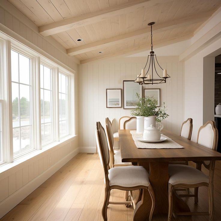 a dining room table with chairs and a potted plant on top of the table