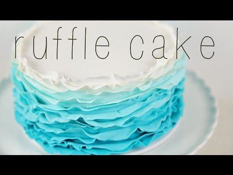 a close up of a cake with blue and white frosting on it's layers