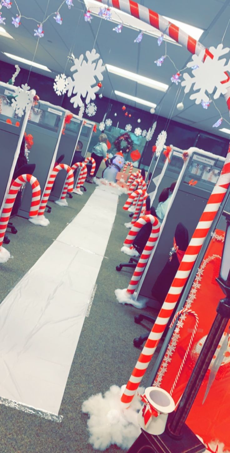 an office cubicle decorated for christmas with candy canes and snowflakes