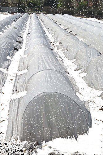 several rows of greenhouses covered in snow