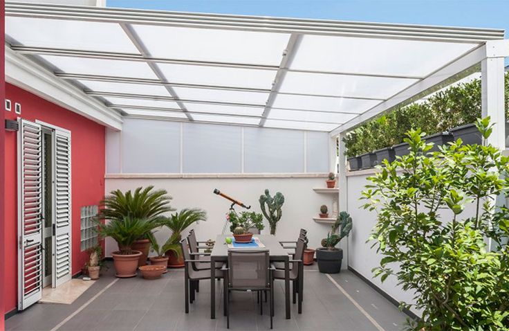 an outdoor dining area with potted plants