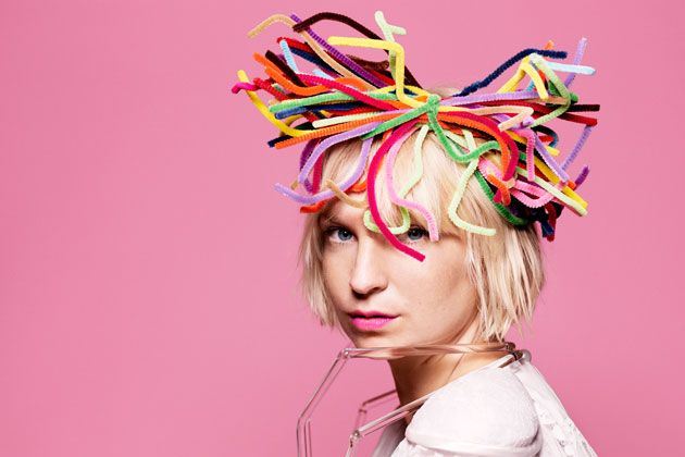 a blonde woman with colorful streamers on her head