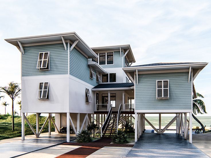 two story blue and white house on the beach