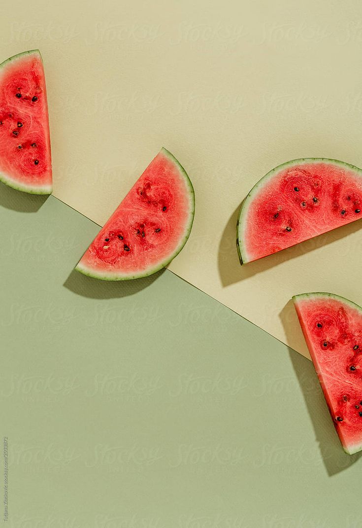 three slices of watermelon with seeds on them